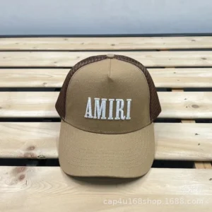 AMIRI Beige Cap: Bold embroidery, trendy